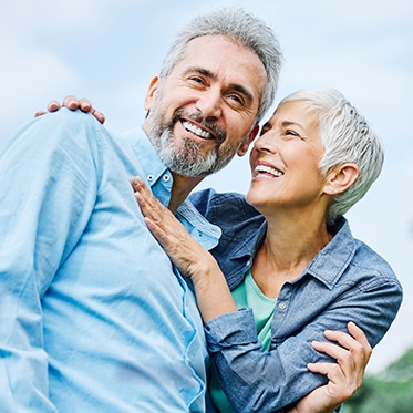 Older Couple Smiling Outdoors Image